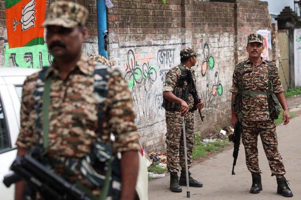 Members of security forces stand guard on Thursday along a road leading to the spot where Chandranath Rath was shot dead. Photo: Reuters