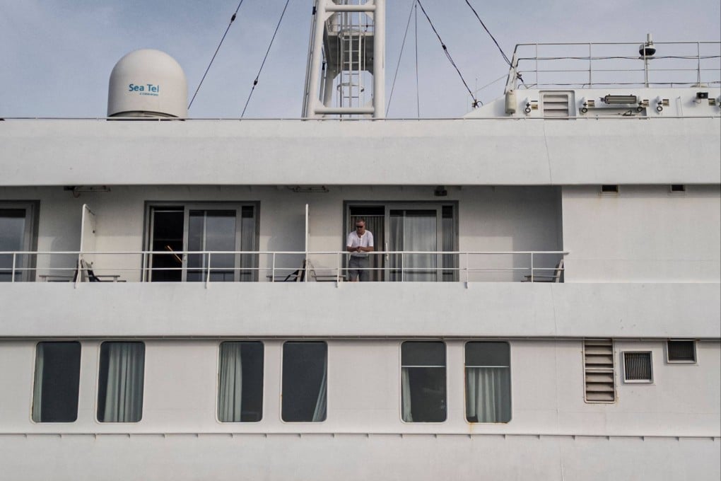 A passenger on the MV Hondius watches as health personnel (not pictured) assist patients off the cruise ship and onto a boat off the port of Praia, Cabo Verde, on Wednesday. Photo: AFP