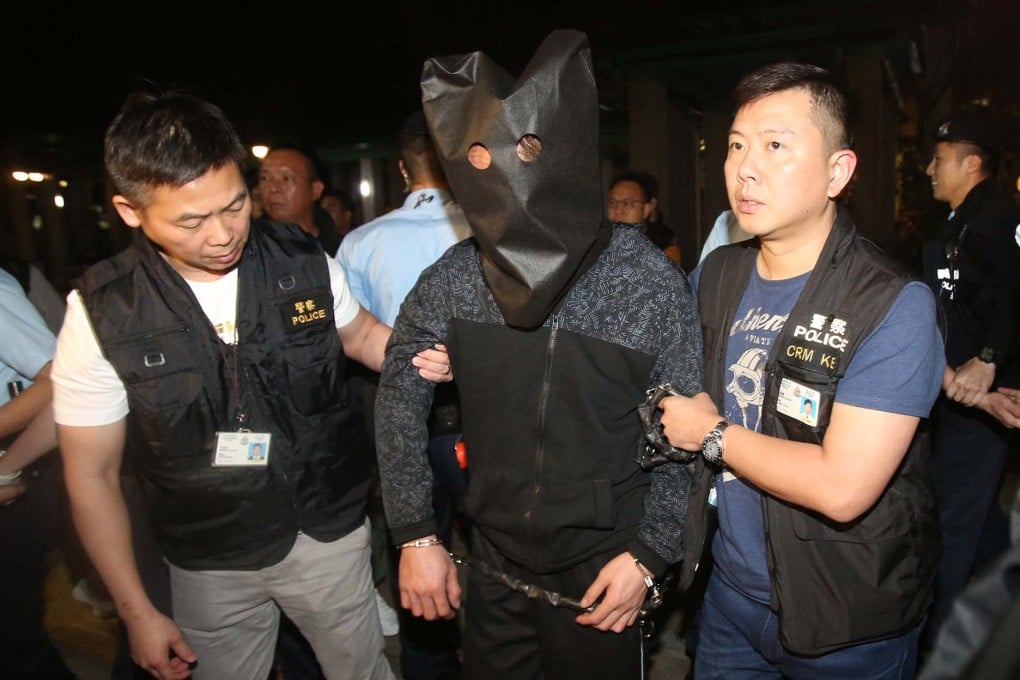 Police escort the murder suspect to Po Lam Estate for investigation in March 2019. Photo: Handout