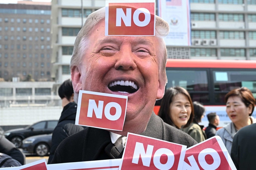 A South Korean protester wears a mask of US President Donald Trump during a protest against Trump’s request to dispatch warships to the Strait of Hormuz, in front of the US embassy in Seoul on March 16. Photo: AFP