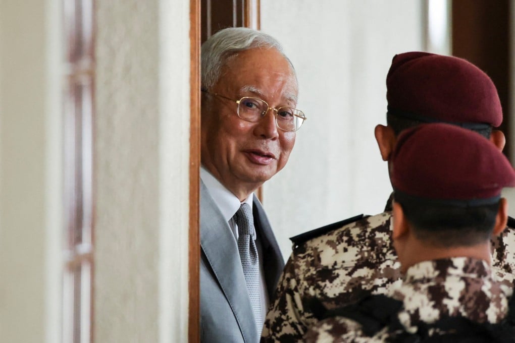 Malaysia’s former prime minister Najib Razak is escorted by prison guards at Kuala Lumpur Courts Complex in December 2025. Photo: Reuters