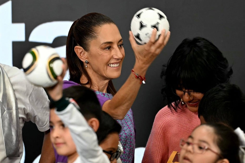 Mexico’s President Claudia Sheinbaum hands out footballs as gifts to children during celebrations marking Children’s Day in Mexico City last month. Photo: AFP