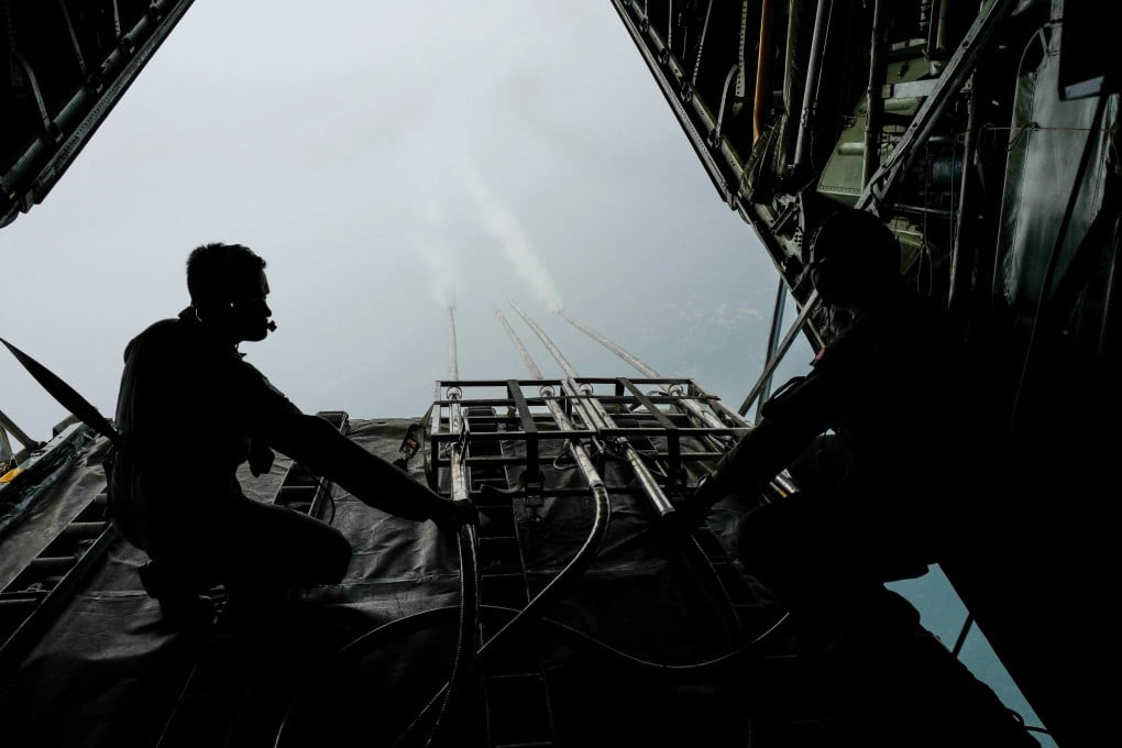 Malaysian air force personnel start the cloud seeding process during a flight over Kedah state in 2019. Photo: AFP