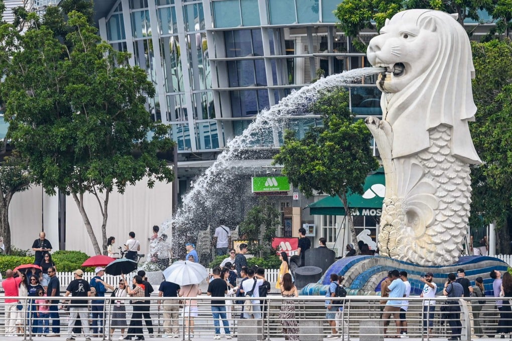 People visit the Merlion statue in Singapore. A recruiter’s comment on the lack of hunger among Singaporean workers compared with their foreign counterparts has sparked a fierce debate. Photo: AFP