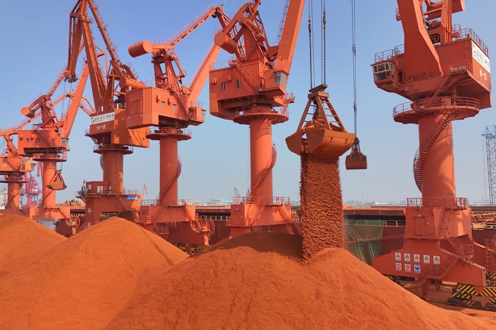Cranes unload bauxite ore imported from Australia at a port in China’s eastern Shandong province. Photo: Reuters