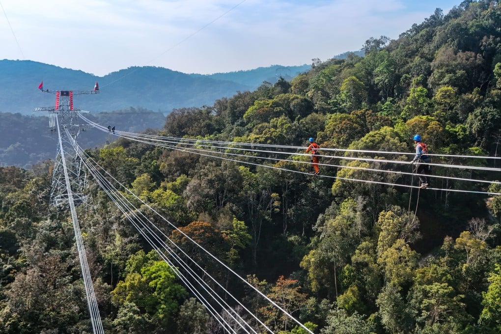 Workers head towards the connection point of the Chinese and Laotian sections of a shared power project on February 5. If China consumes more and saves less, there would likely be less global capital formation. Less infrastructure would be built abroad. Photo: Xinhua
