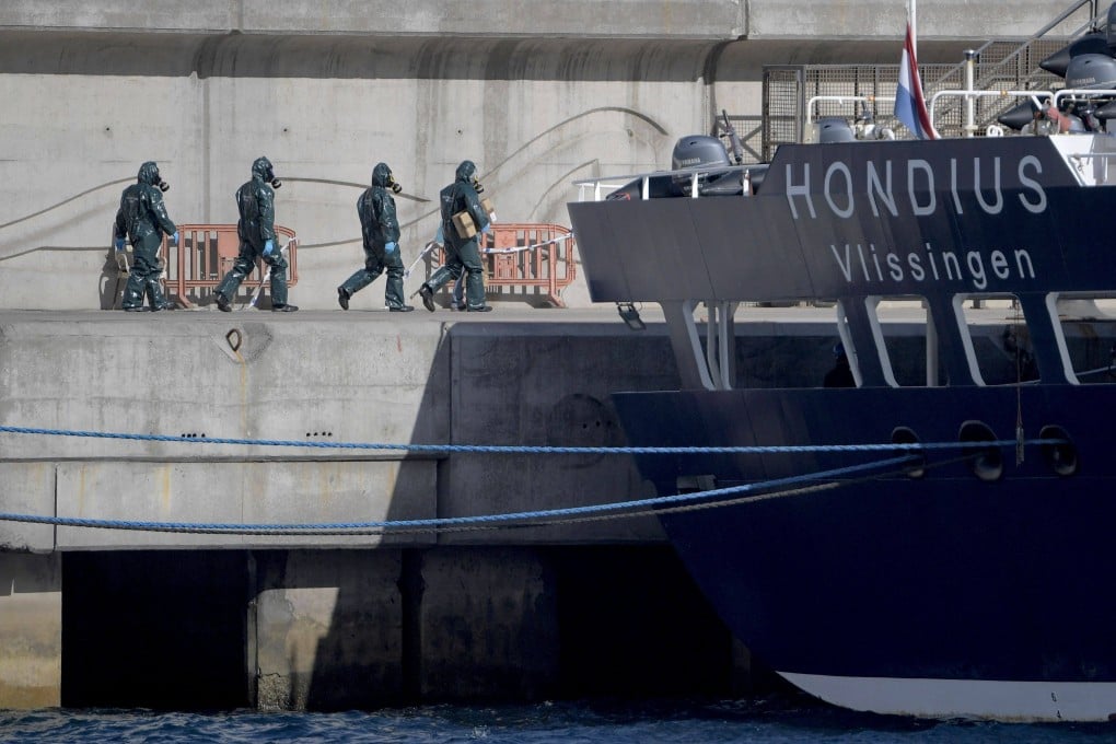 People in protective suits walk towards the MV Hondius on the island of Tenerife, Spain’s Canary Islands on May 11. Photo: AFP