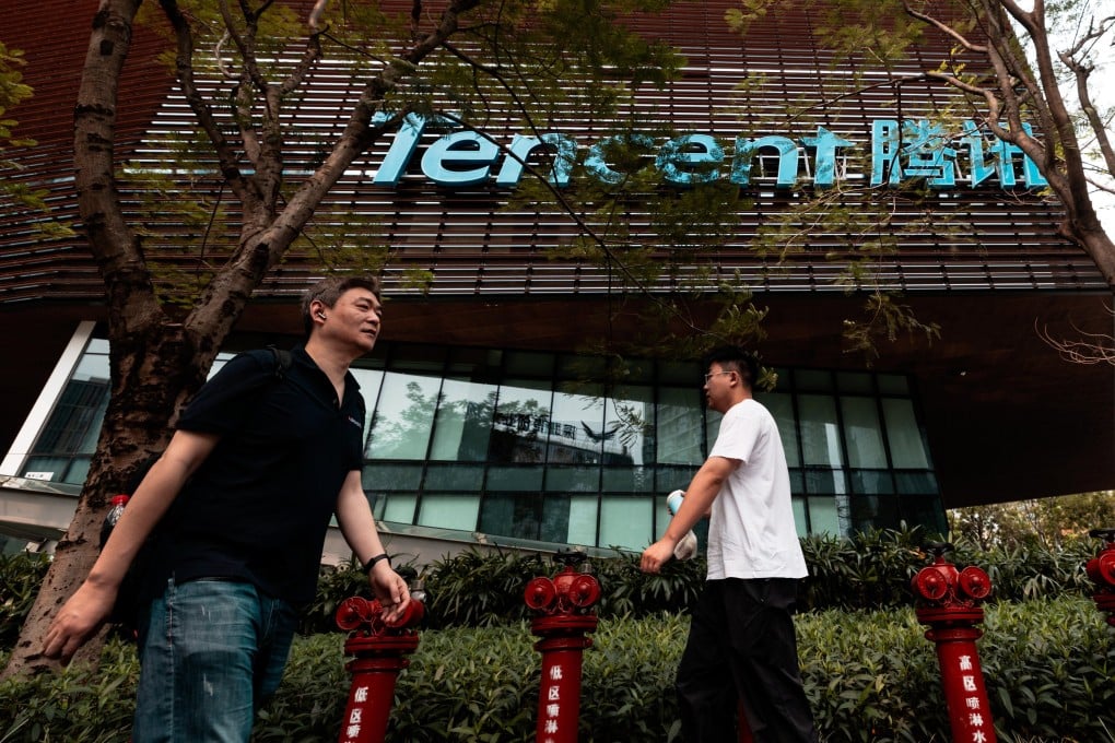 People walk in front of the Tencent headquarters building in Shenzhen. Photo: EPA