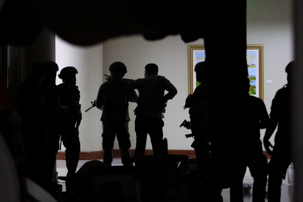 Military personnel enter the Senate building as more than a dozen gunshots were heard at the Philippine Senate on Wednesday. Photo: Reuters