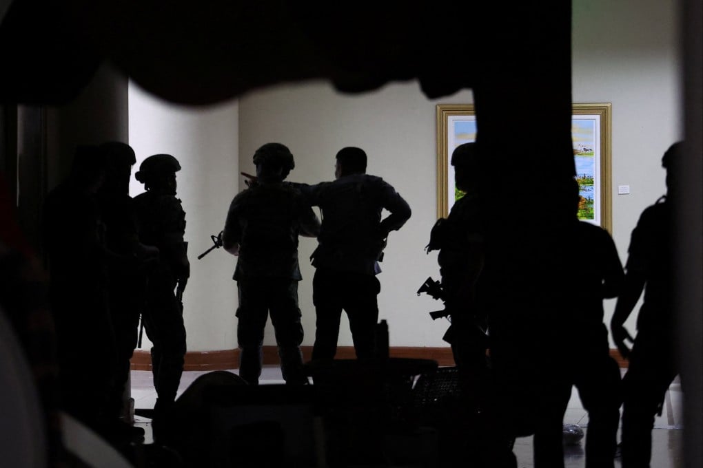 Military personnel enter the Senate building as more than a dozen gunshots were heard at the Philippine Senate on Wednesday. Photo: Reuters