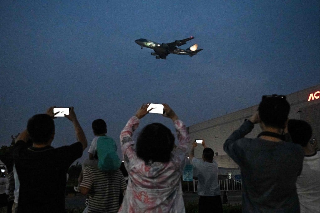 Beijing residents photograph Air Force One as it arrives carrying US President Donald Trump. Photo: AFP