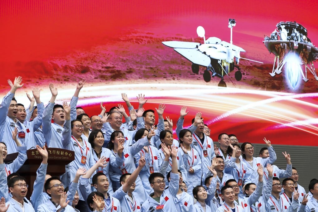 Personnel at the Beijing Aerospace Control Centre celebrate after the Tianwen-1 probe’s lander successfully descended to Mars, carrying the Zhu Rong rover. Photo: Xinhua