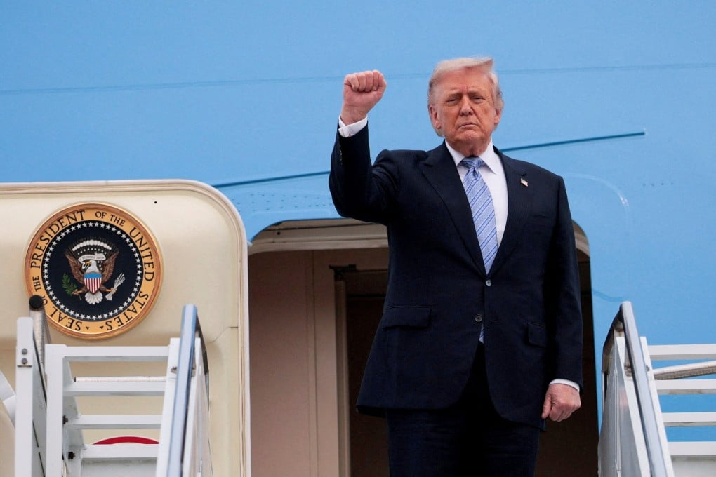 US President Donald Trump gestures as he departs Beijing Capital International Airport aboard Air Force One, in Beijing on Friday. Photo: Reuters