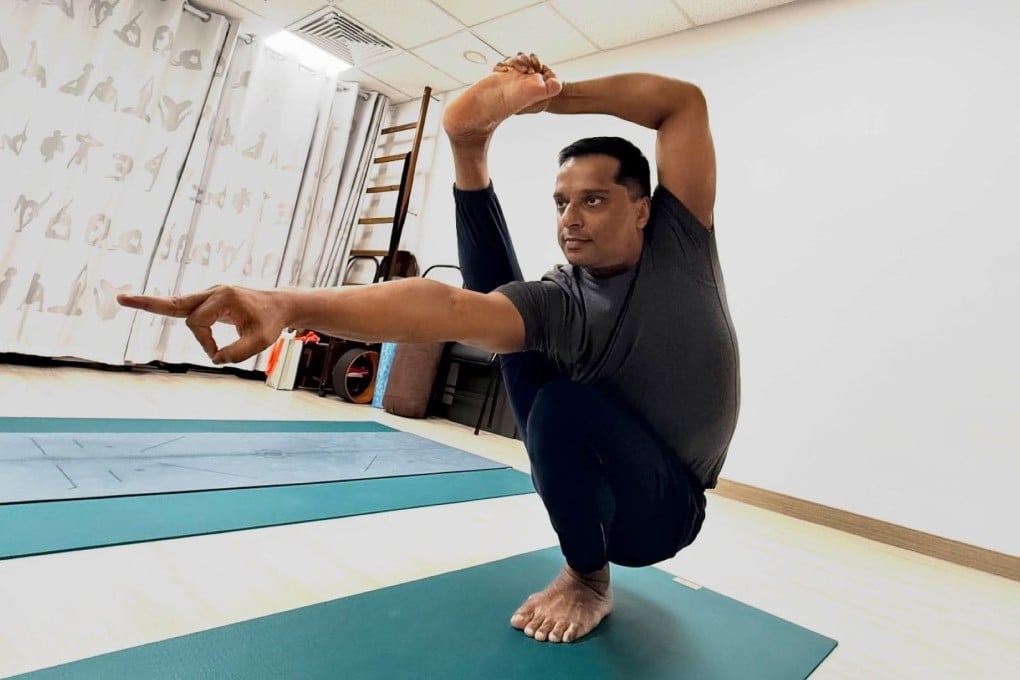 Yogananth Andiappan holds a yoga pose at his Anahata Yoga Studio in Central, Hong Kong. The yoga master recently launched Yogi.live, a AI-powered platform designed to provide users with a more personalised experience. Photo: Facebook.com/masteryogananth
