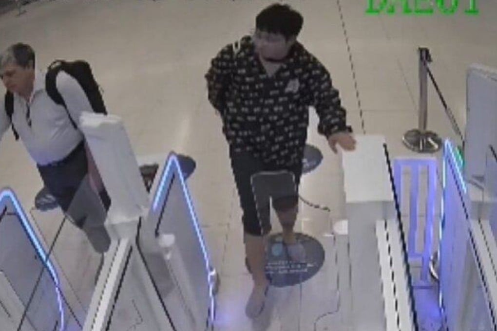 The tourist is seen on CCTV kicking the autogates when they do not open for him. Photo: Handout