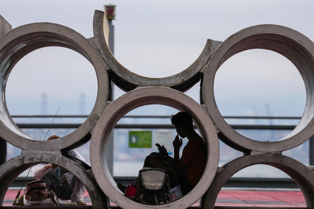 People visit the Central and Western District Promenade. An estimated 520,000 people in Hong Kong are unwilling to confide in friends and relatives or even to seek advice from AI chatbots, according to a survey. Photo: Karma Lo