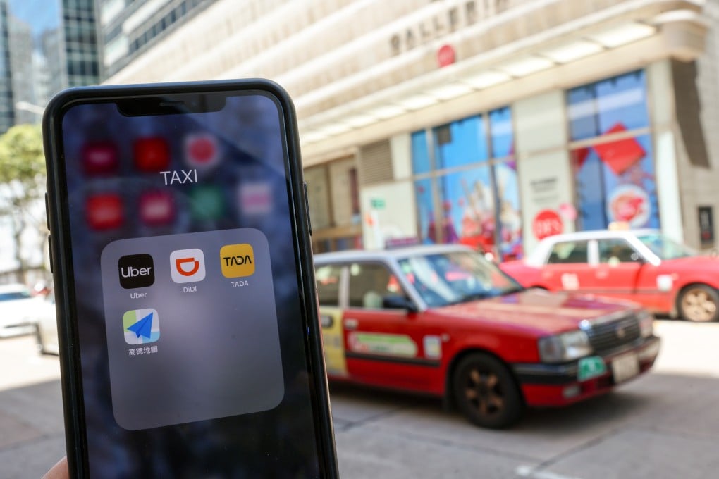 Ride-hailing apps are seen on a mobile phone while a Hong Kong taxi passes by in Tsim Sha Tsui. Photo: Jelly Tse