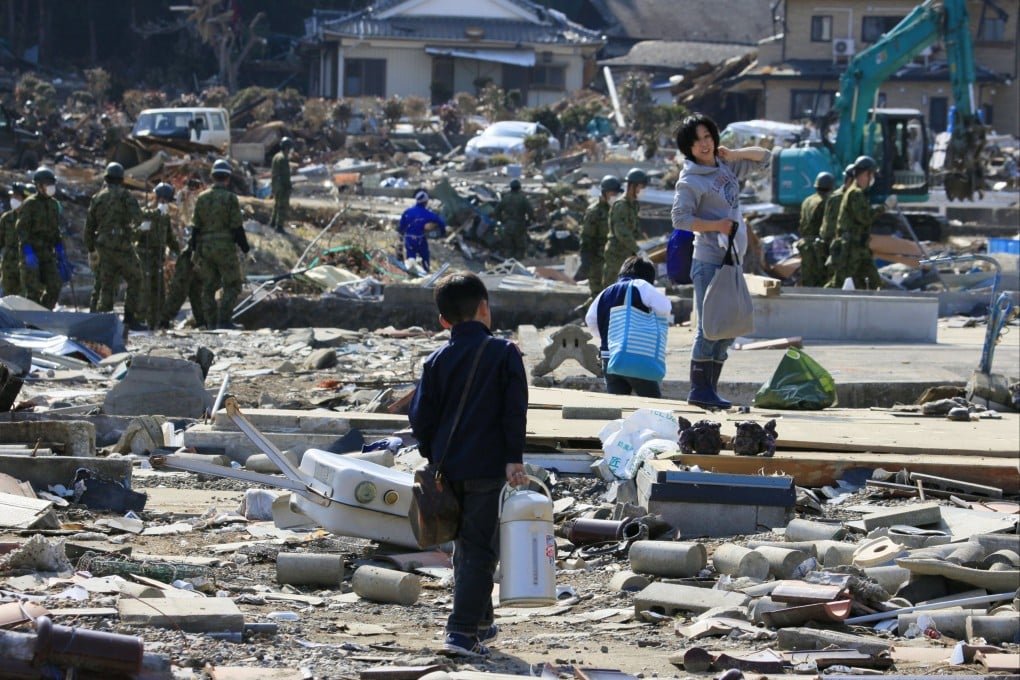 A family retrieve belongings from their destroyed home in Ishinomaki, Miyagi, Japan, on April 10, 2011. Photo: EPA