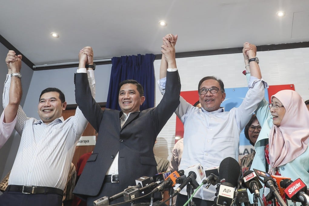 Malaysia’s former economy minister Rafizi Ramli (left) with people’e Justice Party figures, including Prime Minister Anwar Ibrahim (second from right) after Anwar’s election to party president in 2018. Photo: EPA-EFE