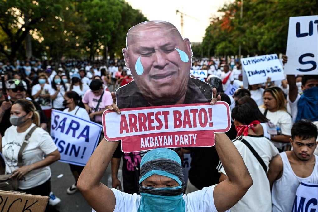 An activist displays a sign with a slogan calling for the arrest of Philippine Senator Ronald ‘Bato’ dela Rosa’s, during a protest outside the Philippine Senate, in Pasay City, Metro Manila, Philippines, on Wednesday. Photo: Reuters