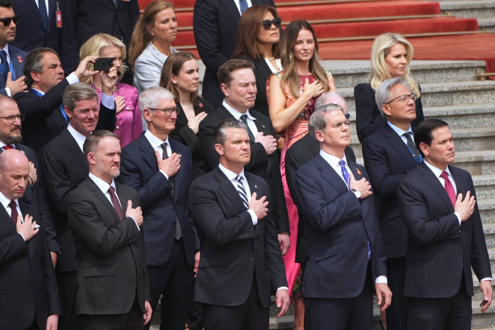 Members of the US delegation listen to the American national anthem as President Donald Trump takes part in a welcome ceremony with Chinese President Xi Jinping at the Great Hall of the People in Beijing on May 14. Photo: AP