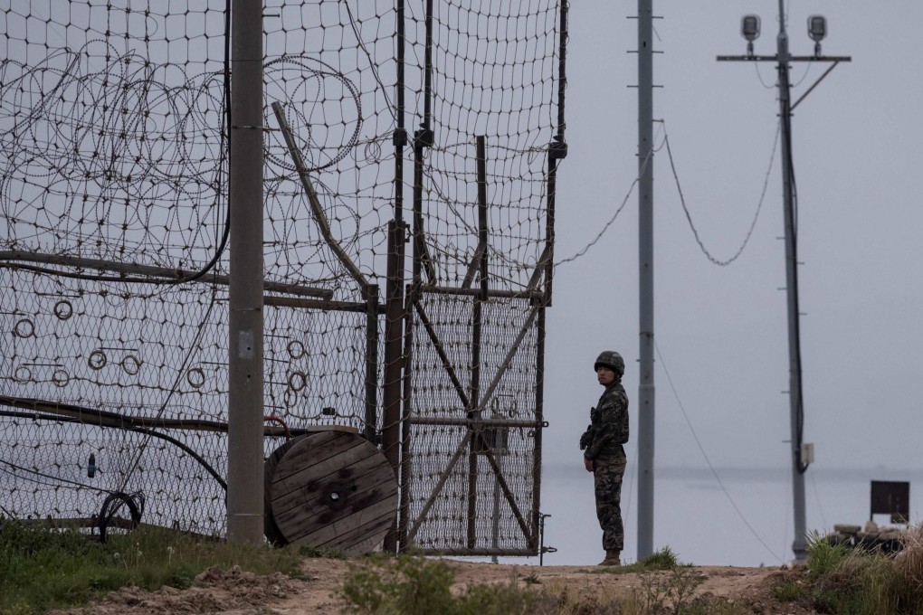 A soldier stands at a fence bordering the demilitarised zone (DMZ) separating North and South Korea in 2017. Photo: AFP