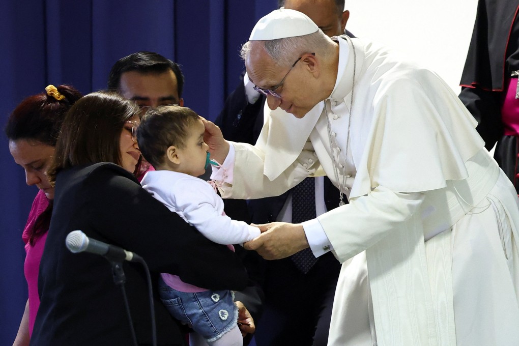 Pope Leo greets a child  in Pompei, Italy, on May 8 as he meets people from socially disadvantaged backgrounds, including the sick and the disabled. Photo: Reuters
