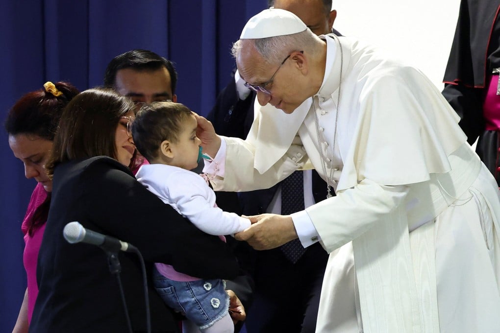 Pope Leo greets a child in Pompei, Italy, on May 8 as he meets people from socially disadvantaged backgrounds, including the sick and the disabled. Photo: Reuters