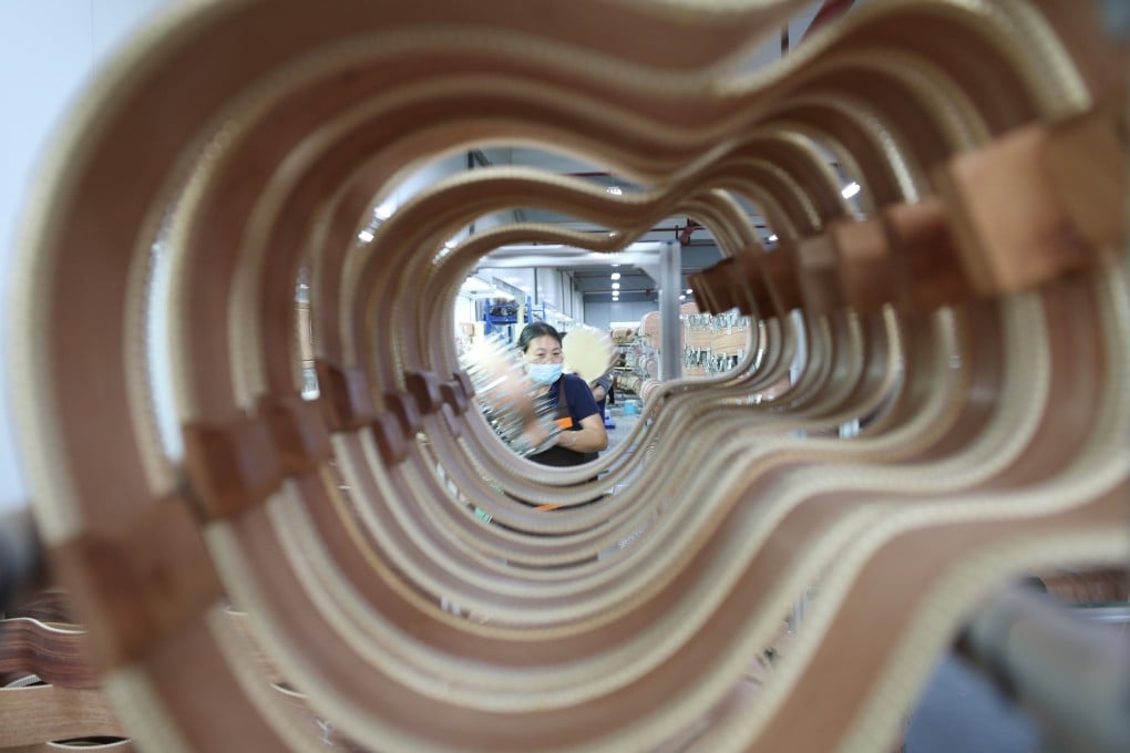 An employee works at a guitar factory in Yongzhou, Hunan province, on May 11. Photo: Xinhua