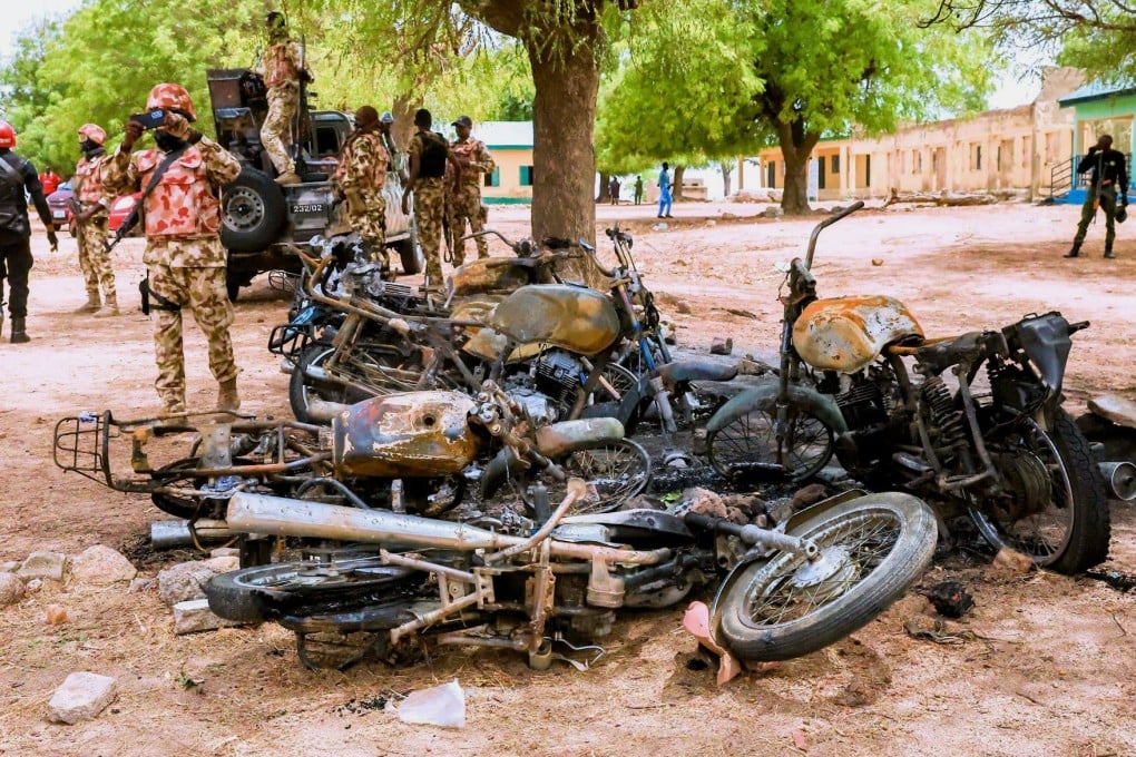 A soldier takes photos of burned motorbikes in Guyaku, northeastern Nigeria, in late April, following an attack by IS militants. The years-long insurgency in the country has seen thousands killed. Photo: via AP