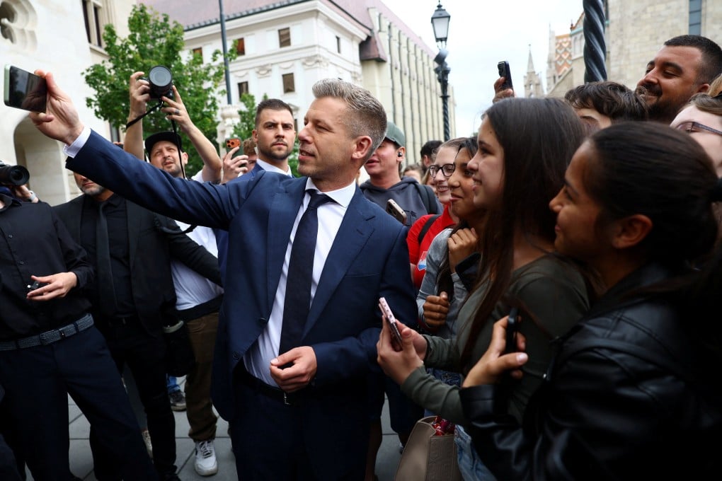 Hungarian Prime Minister Peter Magyar takes a selfie with with people in Budapest on Saturday. Photo: Reuters