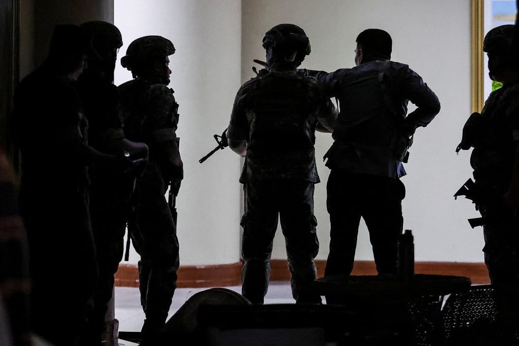 Military personnel enter the Philippine Senate building where Senator Ronald dela Rosa is under protective custody on Wednesday. Photo: Reuters