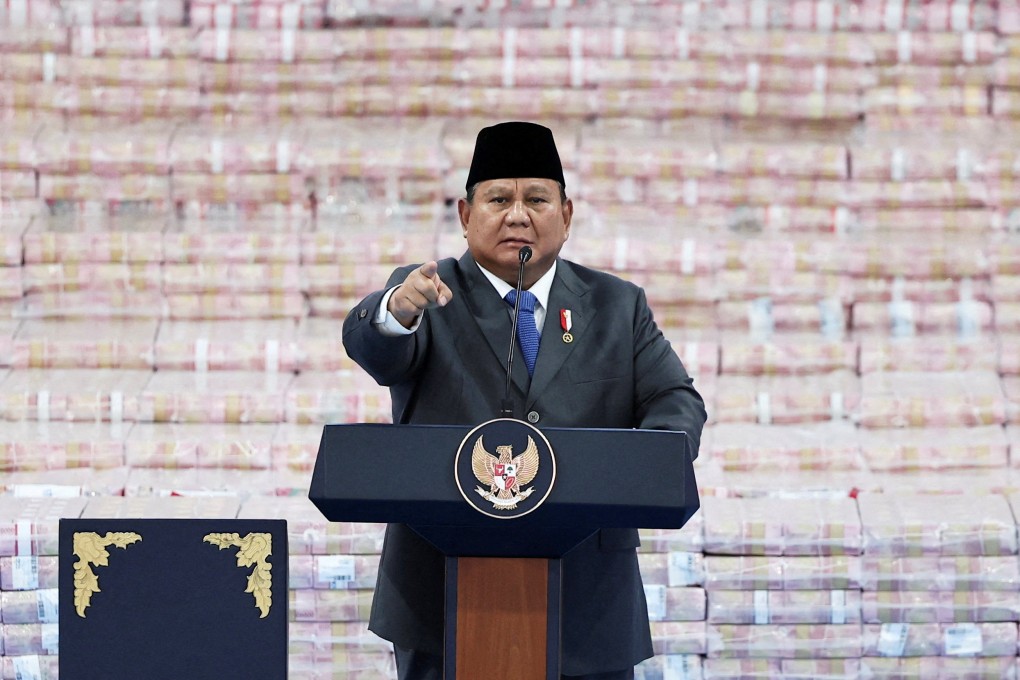 Indonesian President Prabowo Subianto delivers a speech in front of stacks of cash representing the fines paid by companies breaking forestry laws last month. Photo: Reuters