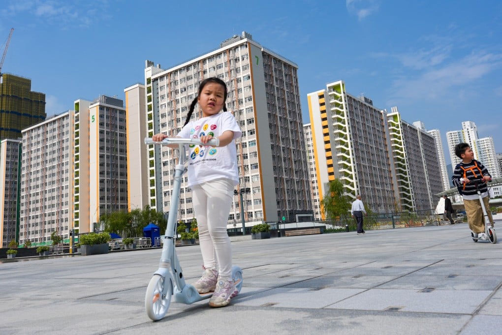 Children ride scooters on the grounds of the Kai Tak Light Public Housing development on February 23. Photo: Jelly Tse