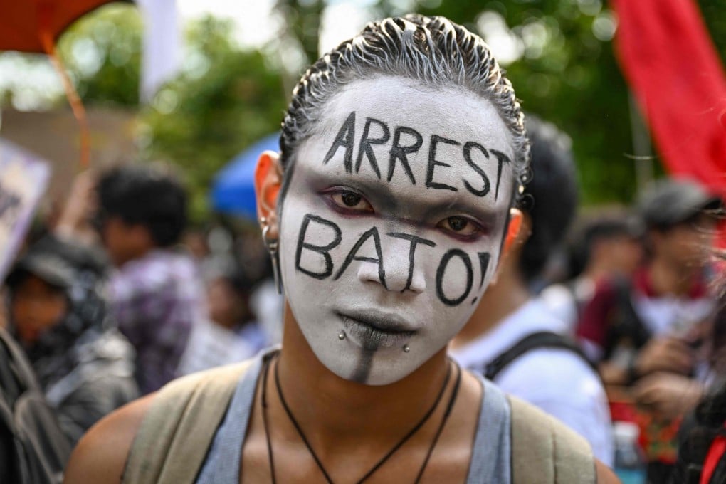 A protester calls for the arrest of Philippine Senator Ronald “Bato” dela Rosa during a demonstration on Monday. Photo: AFP