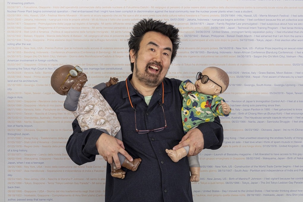 Japanese-American artist Ei Arakawa-Nash holds two of the 208 baby dolls that are part of their exhibition “Grass Babies, Moon Babies” at the 2026 Venice Biennale’s Japan Pavilion. Photo: Uli Holz