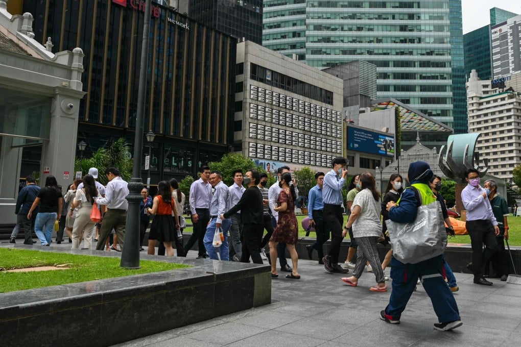Office workers at the Raffles Place financial business district. Singapore has unveiled various measures to help workers cope with AI disruption. Photo: AFP