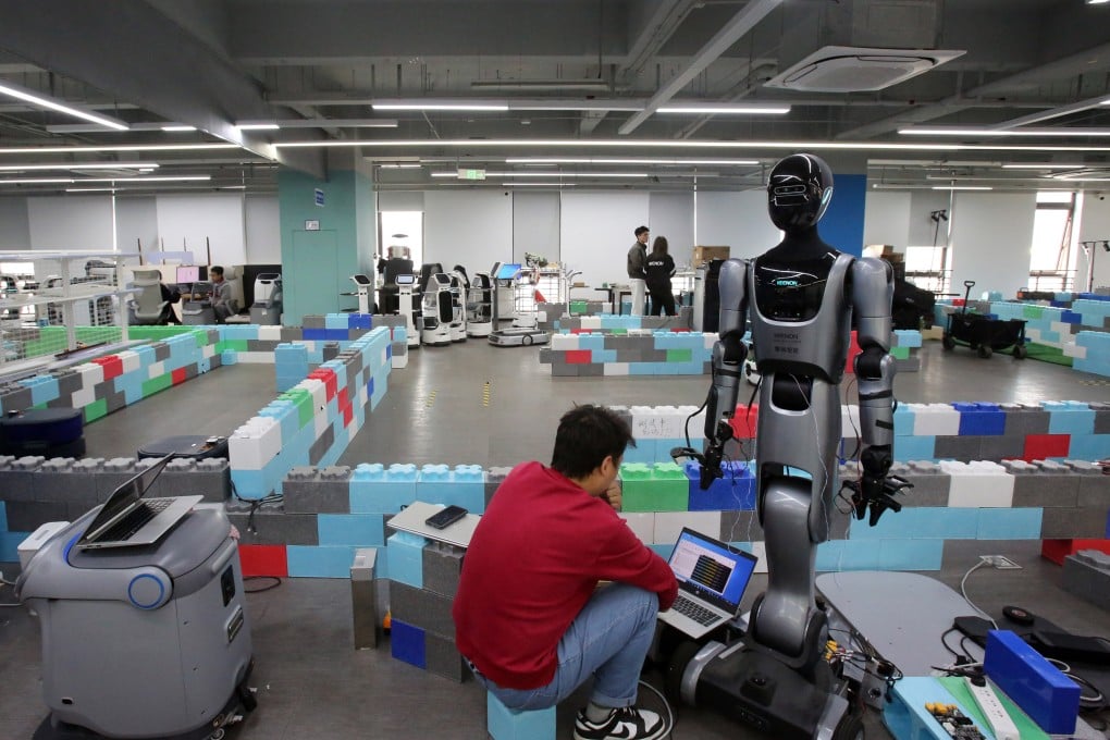 A staff member of Keenon Robotics debugs a humanoid robot in Pudong, Shanghai, on April 2. The robotics industry has attracted private equity interest in China. Photo: Xinhua