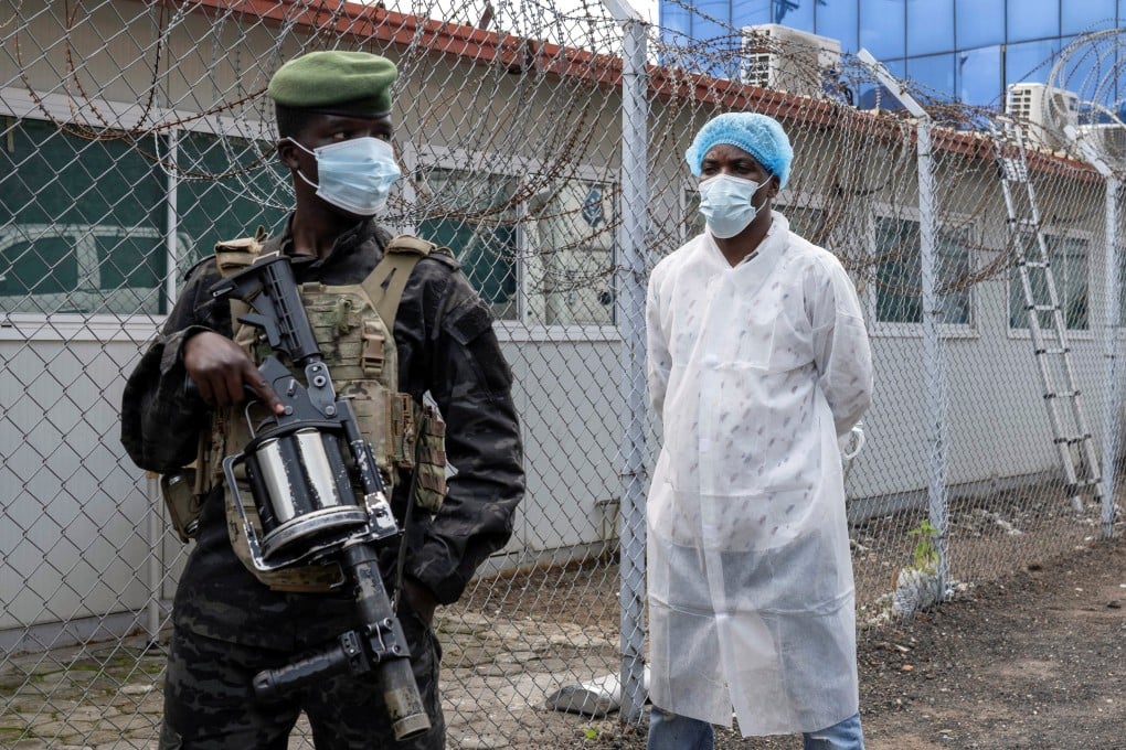 An armed M23 rebel guards the Rodolphe Merieux Laboratory in Goma, DR Congo, where suspected cases of the rare Ebola strain are being tested. Photo: Reuters