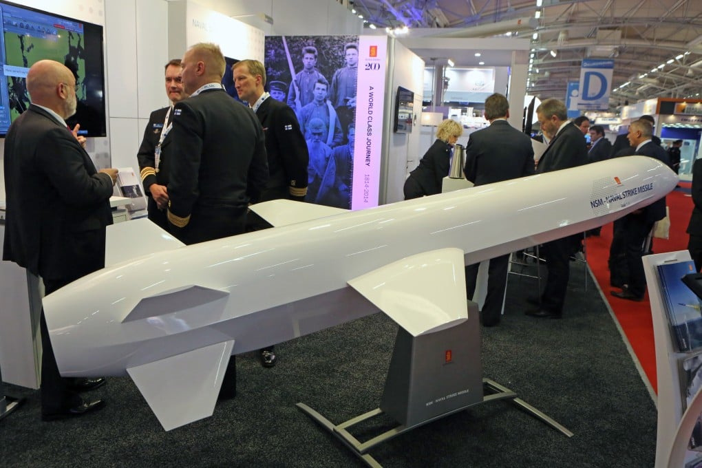 Visitors gather next to a display of an NSM Naval Strike Missile made by Norwegian company Kongsberg, at the Euronaval show, in Le Bourget, France in 2014. Photo: AP
