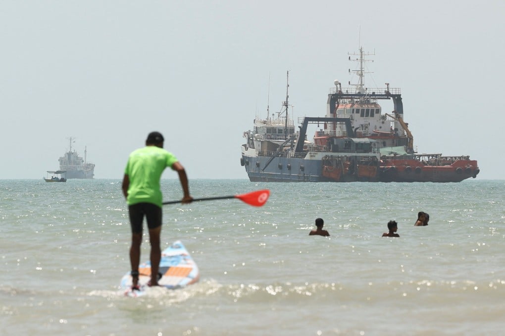 Ships and swimmers are seen in the Strait of Hormuz on Thursday. The strategic waterway has been largely closed to traffic since the Iran war began. Photo: WANA via Reuters