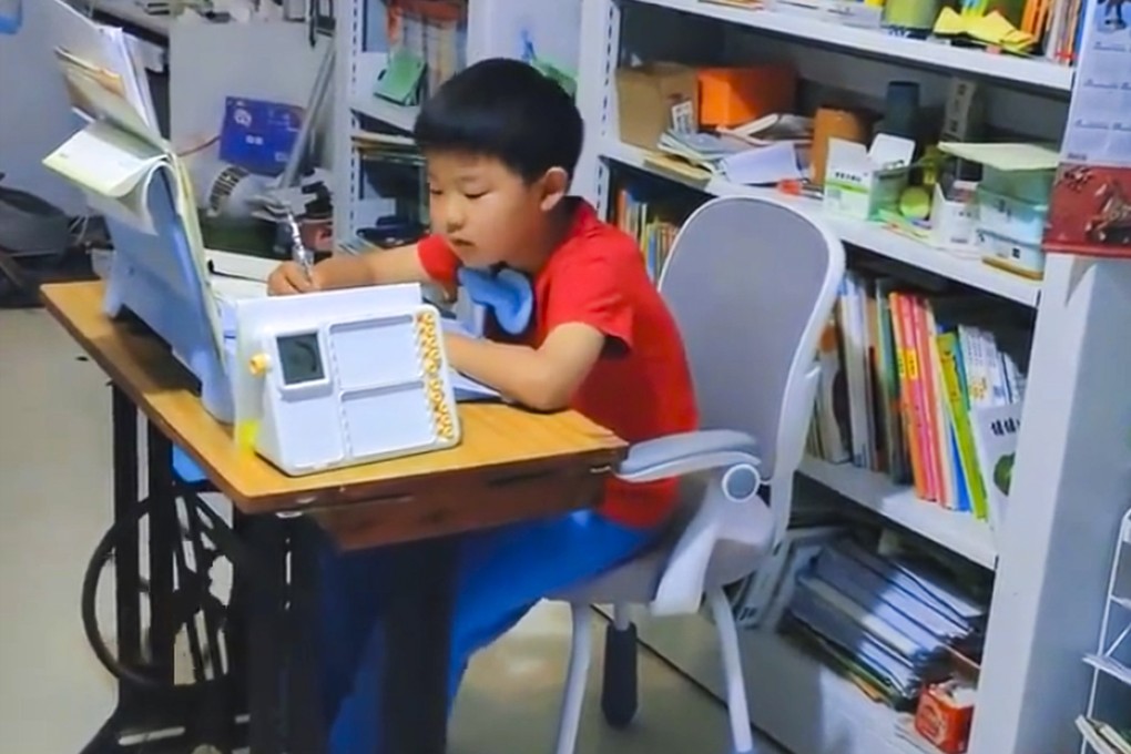 A mother in China has improved her son’s focus while he is doing homework by having him peddle a sewing machine as he works. Photo: Web