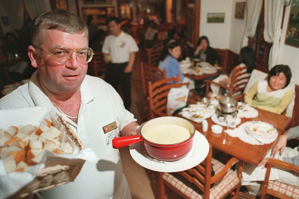 The Swiss Chalet’s Lax Liechti serves cheese fondue to guests at the restaurant in Tsim Sha Tsui, Hong Kong, in February 1999. Photo: SCMP