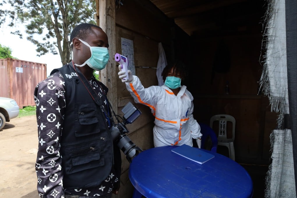 A medical worker checks temperature for a local journalist in Bunia, in the Democratic Republic of the Congo on Thursday. Photo: Xinhua