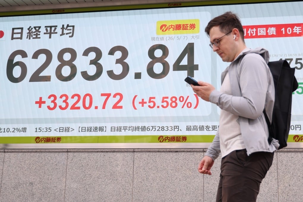 A man walks past a digital stock display in Tokyo on May 7. Photo: EPA