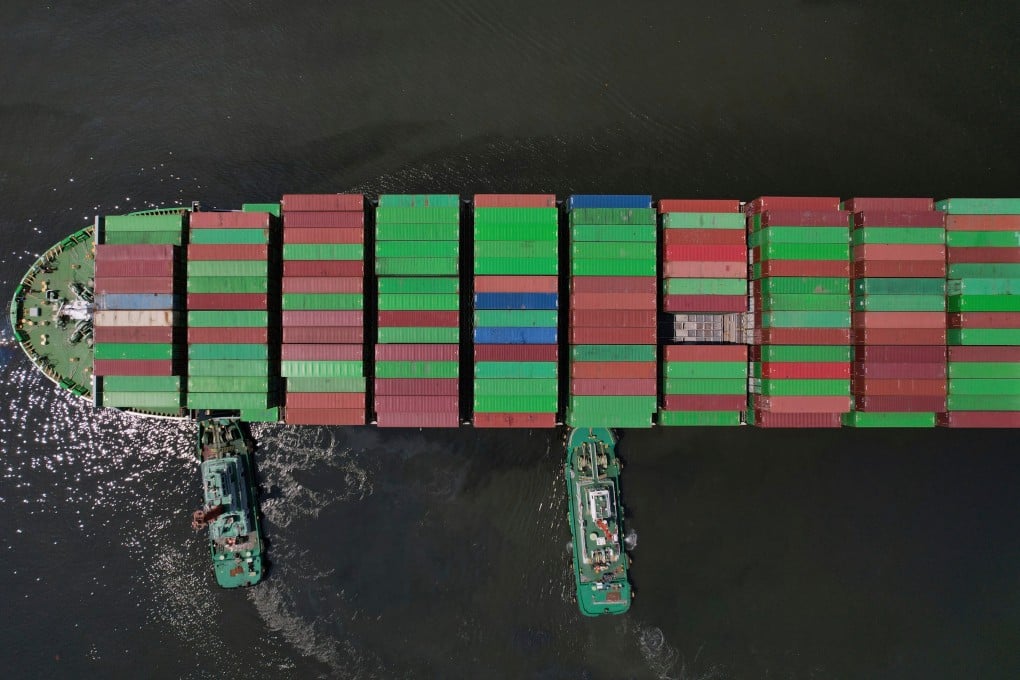 Tugboats assist a container ship as it prepares to dock at the Manila International Container Terminal on April 8. Photo: AP