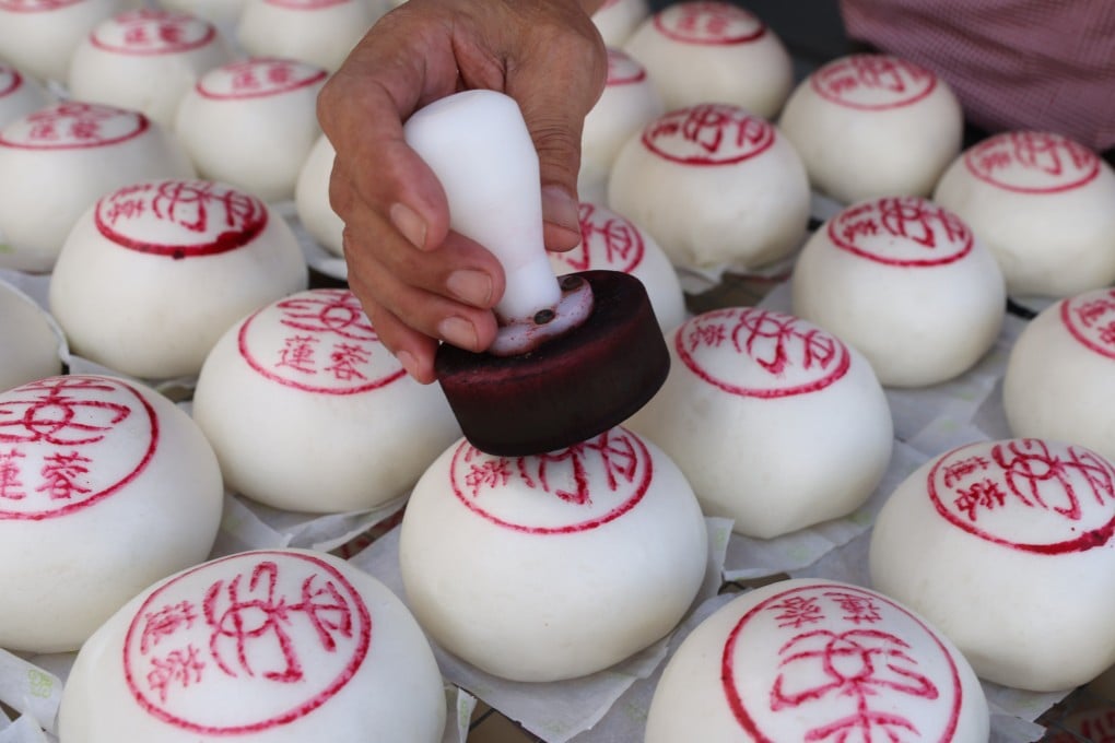 An employee of Kwok Kam Kee, a bakery on Hong Kong’s Cheung Chau island, prepares traditional ping on bao, or “peace buns”, ahead of the annual Cheung Chau Bun Festival. Photo: Yik Yeung-man