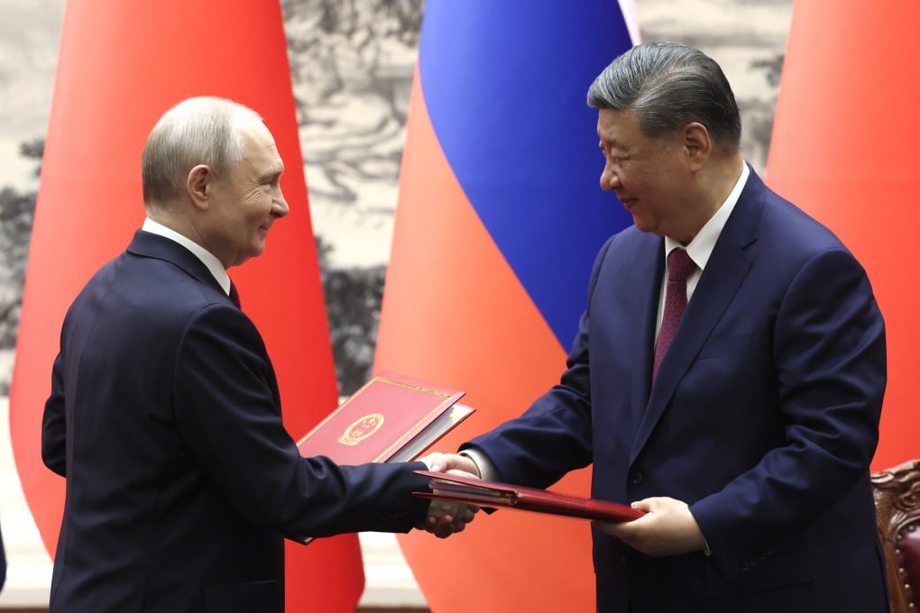 Presidents Xi Jinping and Vladimir Putin shake hands during a signing ceremony at the Great Hall of the People, in Beijing on May 20. Photo: EPA