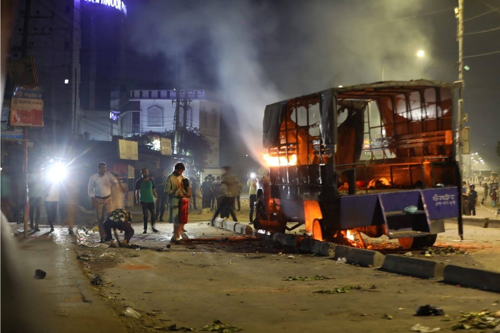 A police vehicle is set ablaze by people protesting against the alleged rape of a girl, in Chattogram, Bangladesh on Thursday. Photo: AFP
