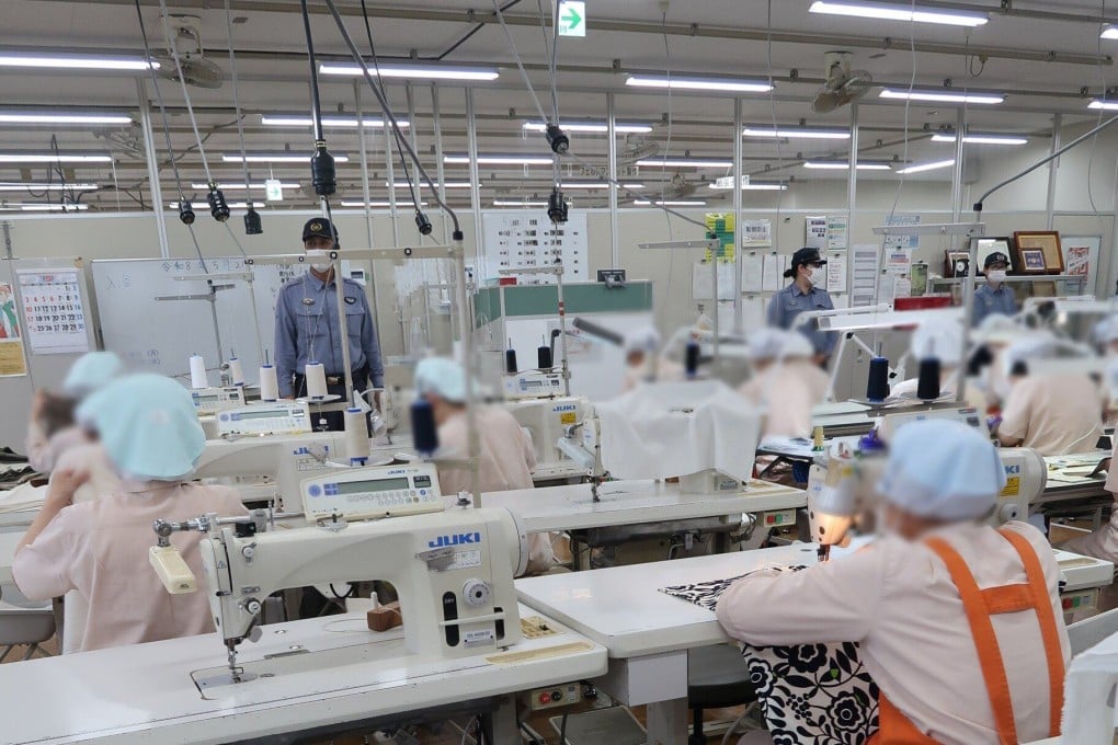 Inmates in Tochigi Prison’s factory in Japan sew flags and banners. Photo: Julian Ryall